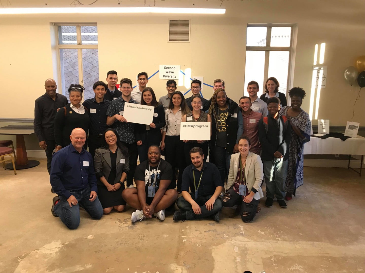 A group poses at The Armada with Second Wave Diversity and PMA program signs.